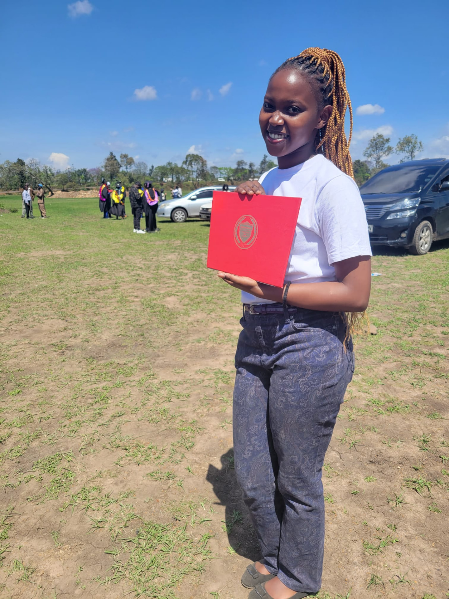 Graduate holding her certificate folder after the ceremony