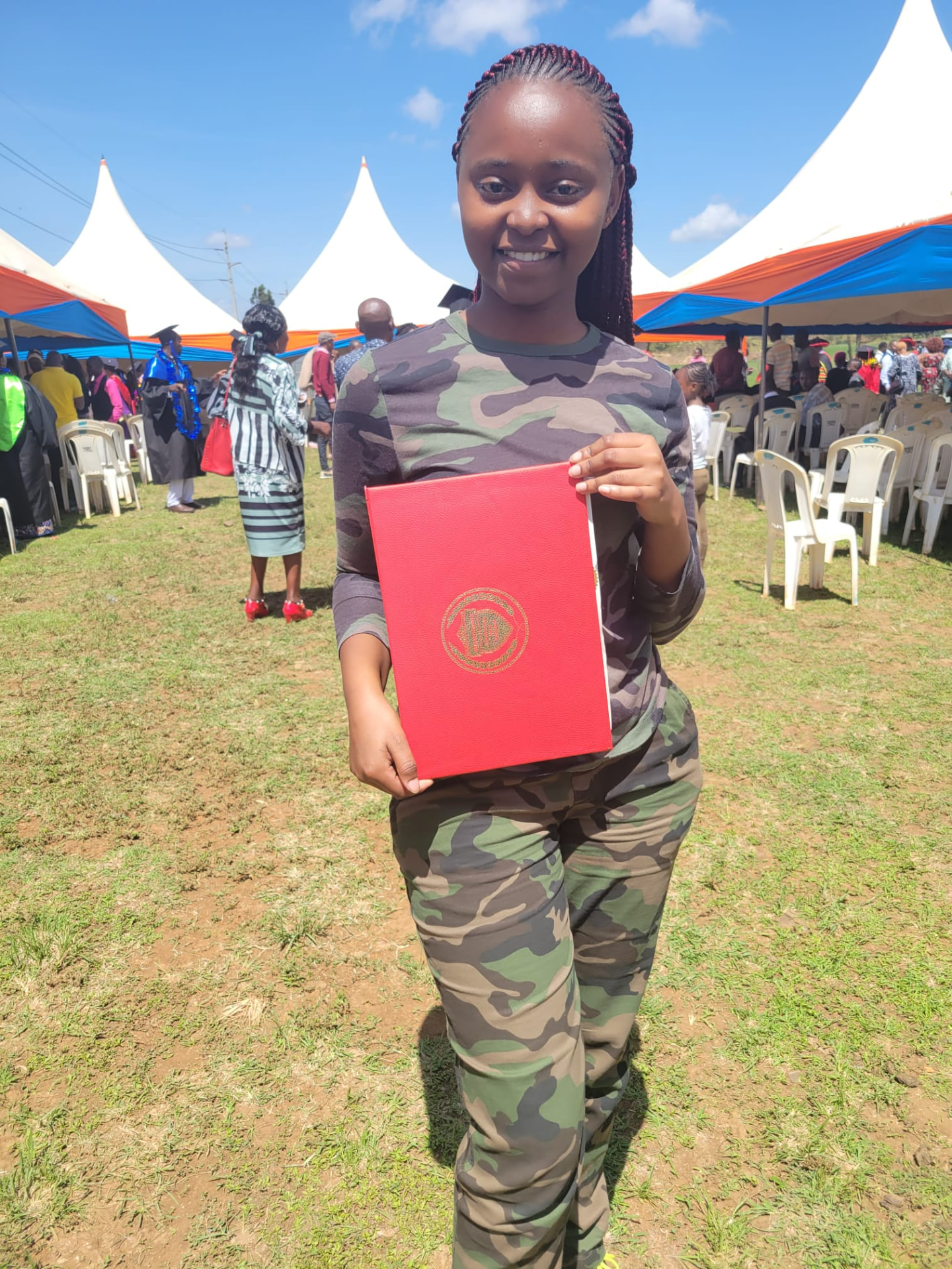 Smiling graduate displaying her certificate